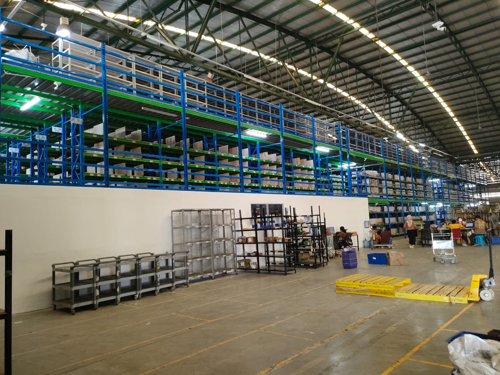 Area rak gudang FMCG dengan mezzanine dalam tahap konstruksi